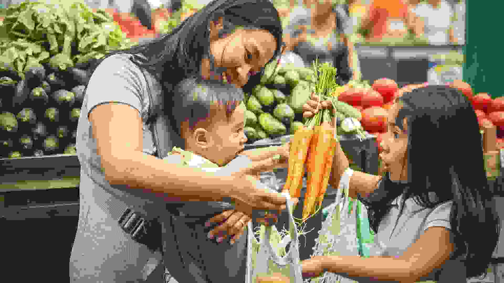 Mother with kids shopping in market stock photo
