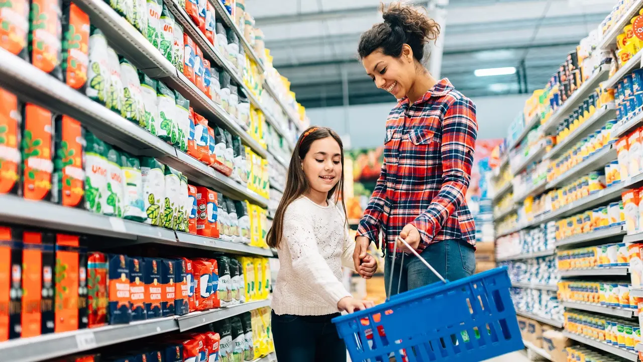 Mother and Daughter Shopping in Supermarket stock photo
