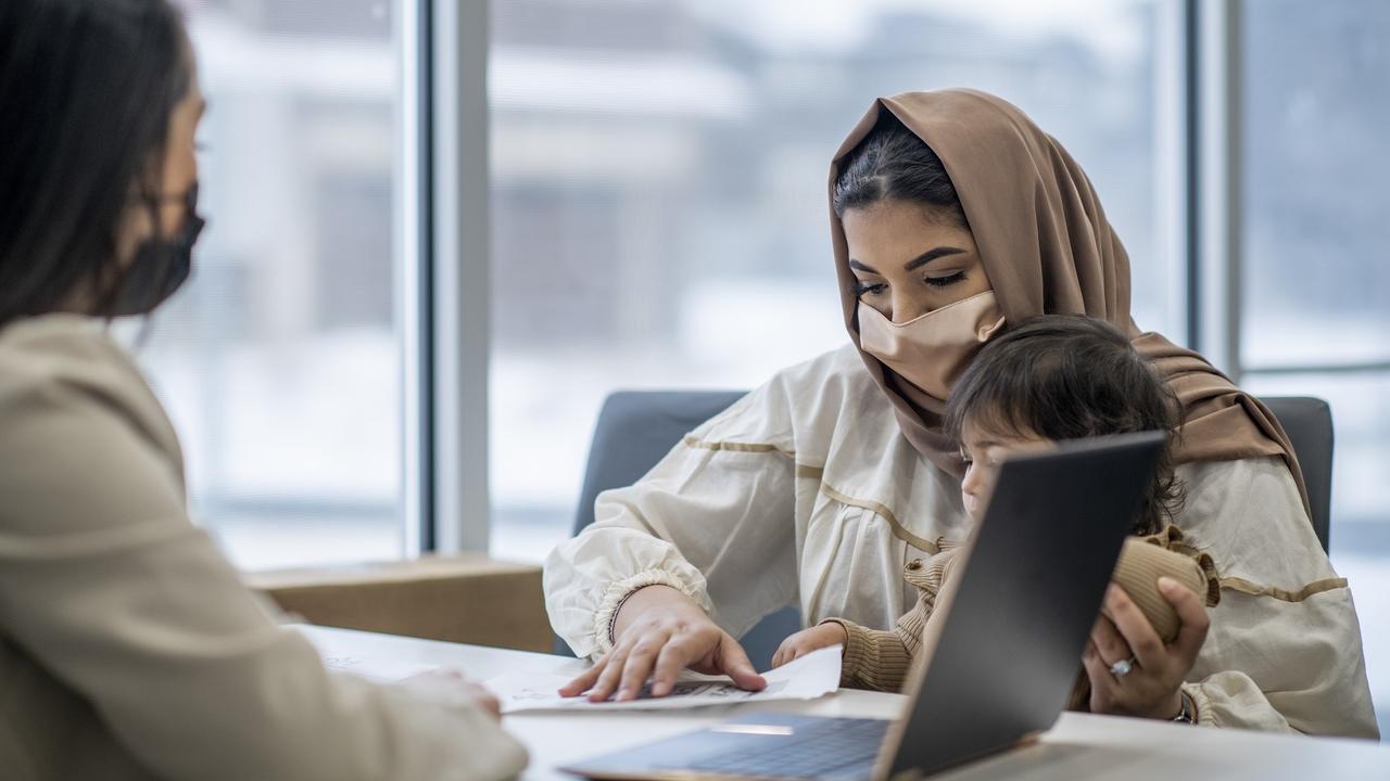 Muslim woman planning for her child's education savings stock photo