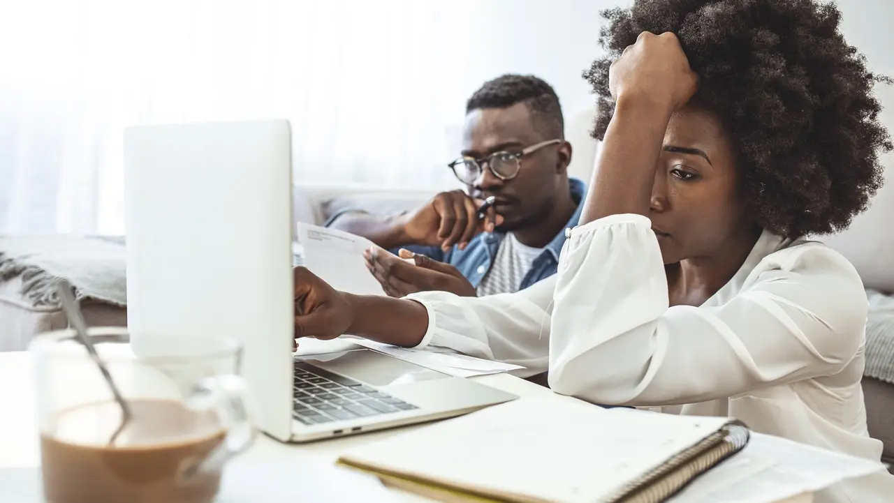 Serious African American couple discussing paper documents stock photo