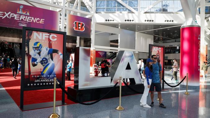 Mandatory Credit: Photo by CAROLINE BREHMAN/EPA-EFE/Shutterstock (12792488ac)Fans pose in front of an 'LA' sign at the NFL Experience in Los Angeles, California, USA, 06 February 2022.