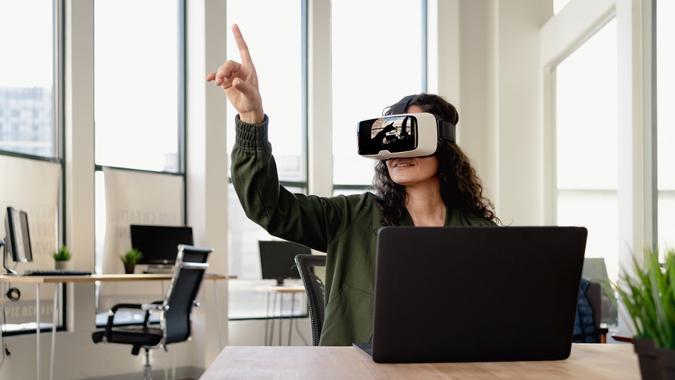 Woman in office wearing VR glasses at meeting stock photo