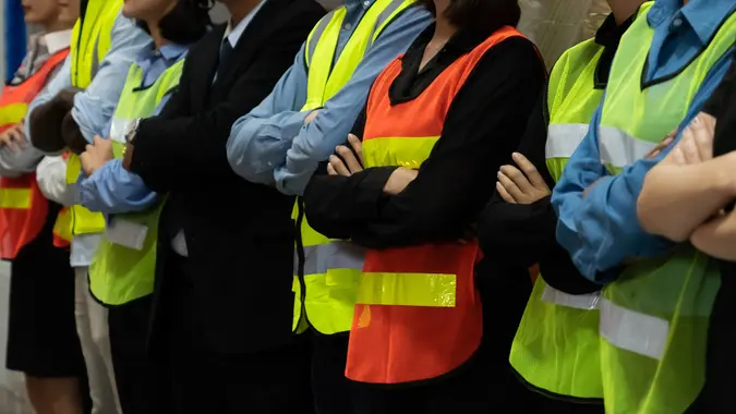 Large group of factory worker standing together in warehouse or storehouse stock photo