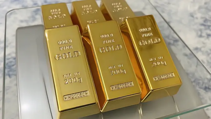 Close up gold bars on precision scales stock photo