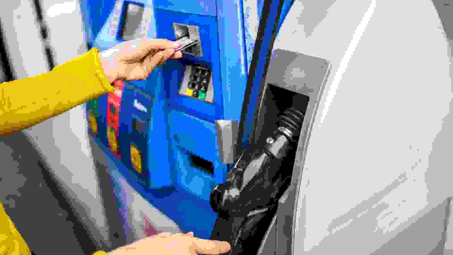 Making a payment for gas at a fuel station.