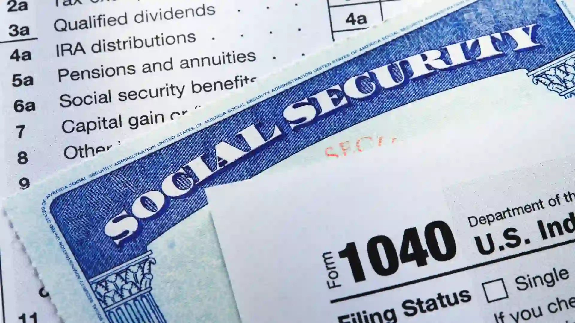 A Social Security card rests in between the pages of a 1040 tax form.