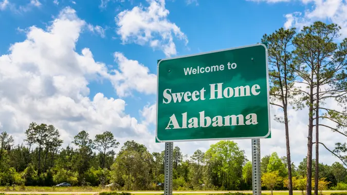 Welcome to Sweet Home Alabama Road Sign along Interstate 10 in Robertsdale, Alabama USA, near the State Border with Florida.