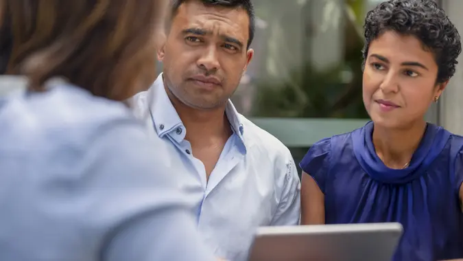 Concerned couple having a business meeting with a financial advisor. stock photo