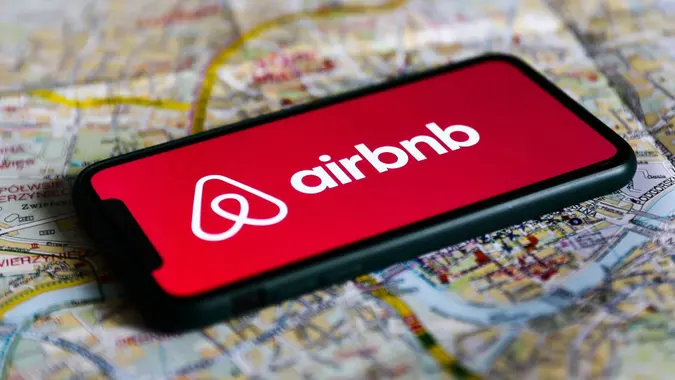 Mandatory Credit: Photo by Jakub Porzycki/NurPhoto/Shutterstock (12311786a)Airbnb logo displayed on a phone screen and a map of Krakow are seen in this illustration photo taken in Krakow, Poland on August 17, 2021.