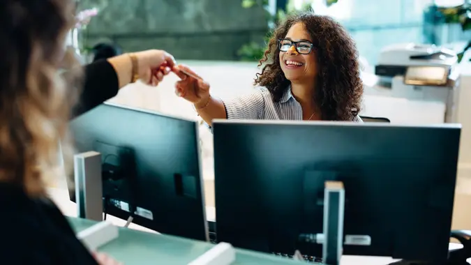 Administrator assisting a female at municipal office stock photo