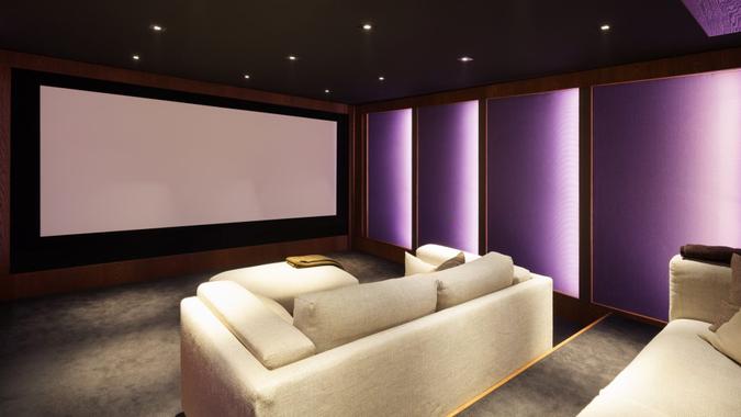 Home theater, luxury interior, comfortable divan and big screen.