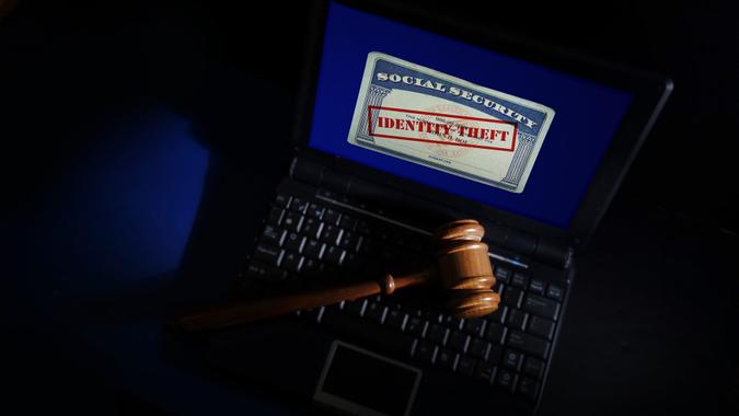 Legal gavel on a laptop with Identity Theft Social Security card.