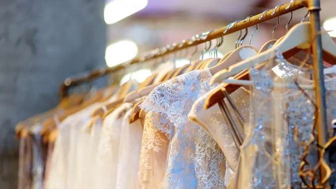 A few beautiful wedding dresses on a hanger.