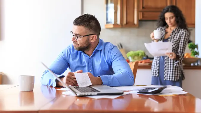 Young woman sitting at home and making home finances, with casual clothes.
