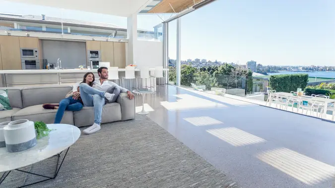 Couple sitting in a modern open plan house.