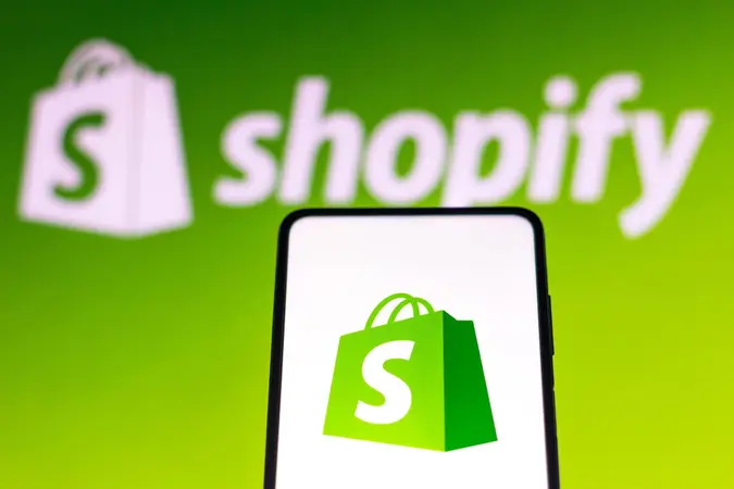 Mandatory Credit: Photo by Rafael Henrique/SOPA Images/Shutterstock (12601013c)In this photo illustration a Shopify logo seen displayed on a smartphone screen and in the background.
