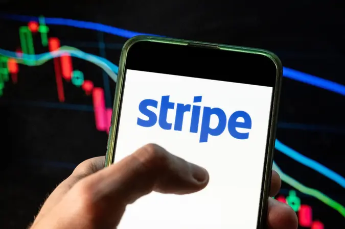 Mandatory Credit: Photo by Budrul Chukrut/SOPA Images/Shutterstock (12748484b)In this photo illustration the online payment platform Stripe logo seen displayed on a smartphone with an economic stock exchange index graph in the background.
