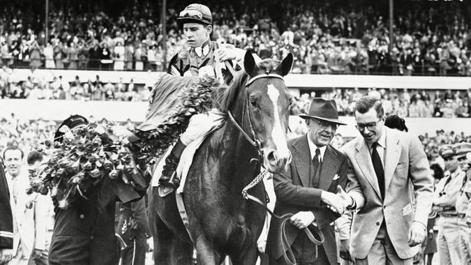 Mandatory Credit: Photo by AP/Shutterstock (6663835a)King Ranch?s Middle ground, his Jockey Willie Boland, and his trainer, Max Hirsch, (holding bridle) enter the winner?s circle at Churchill Downs, Louisville, after Middle ground?s victory in the 76th running of the Kentucky Derby.