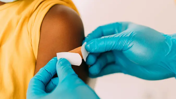 Doctor putting a bandage after Covid-19 vaccination. stock photo