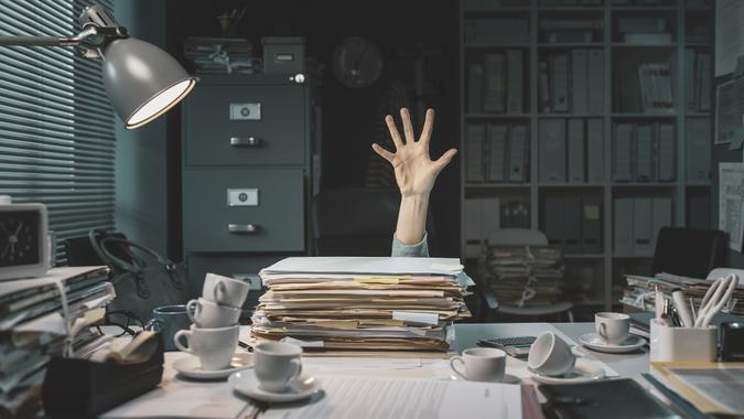 Office worker overwhelmed with paperwork stock photo
