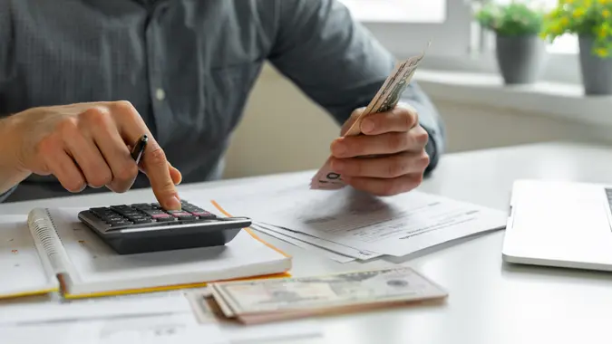Man using calculator.