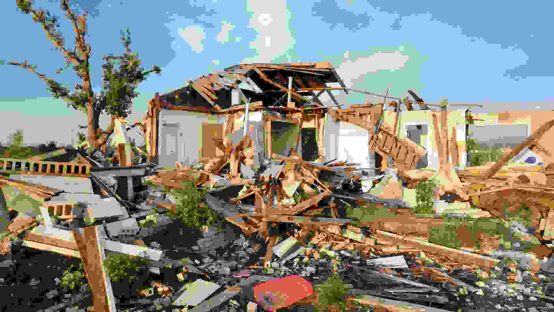 "Close up of home destroyed by tornado, horizontal panorama.