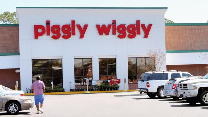 Johns Island, SC, USA - March 13, 2011:  A man walks towards a Piggly Wiggly Supermarket from the store parking lot.