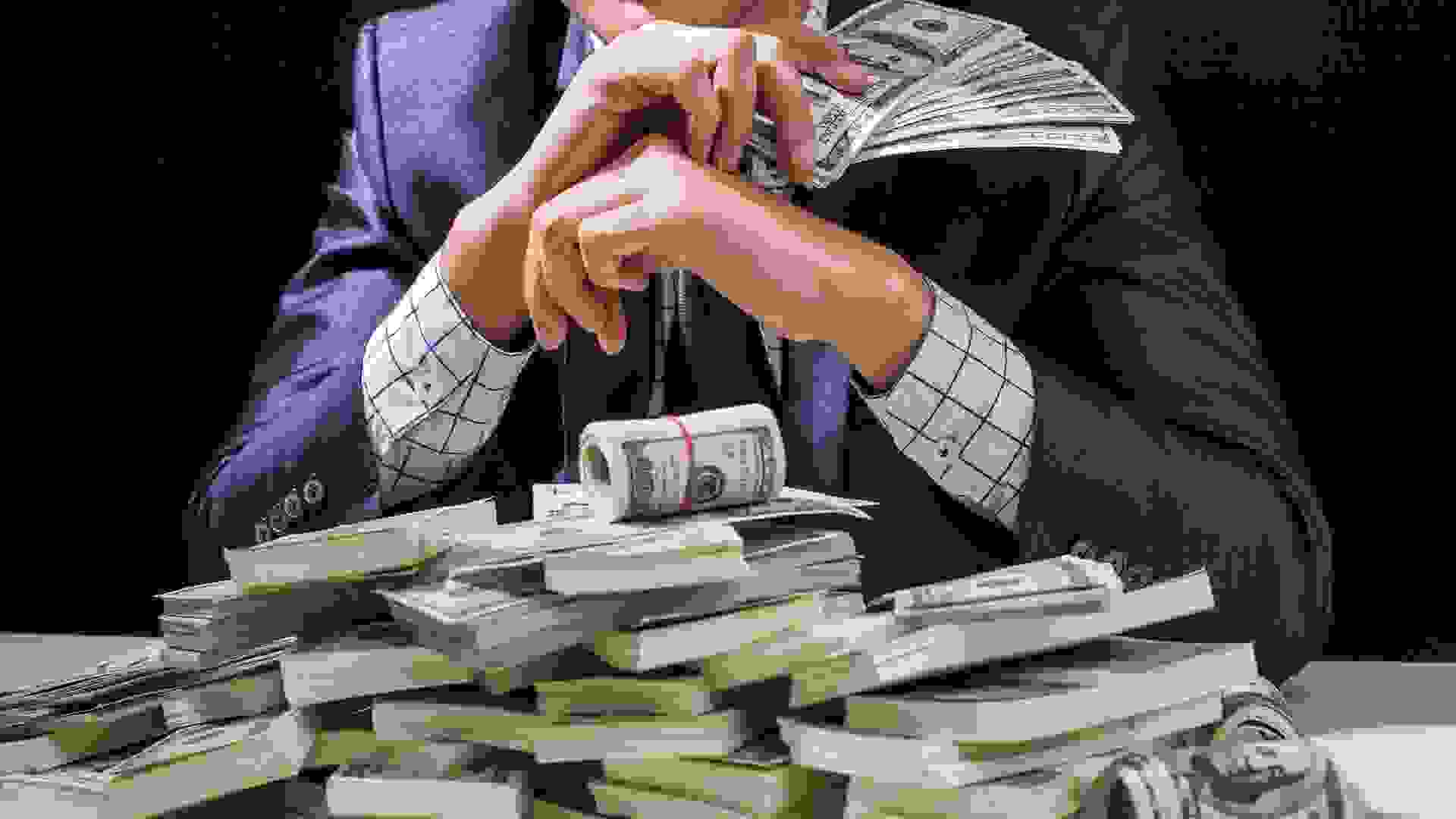 Man holding Money in hand at Black Background, Man receive a lot Money from Trading, Business Success Concept.
