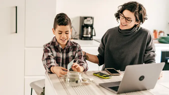 Boy learning math with cash and money planning stock photo