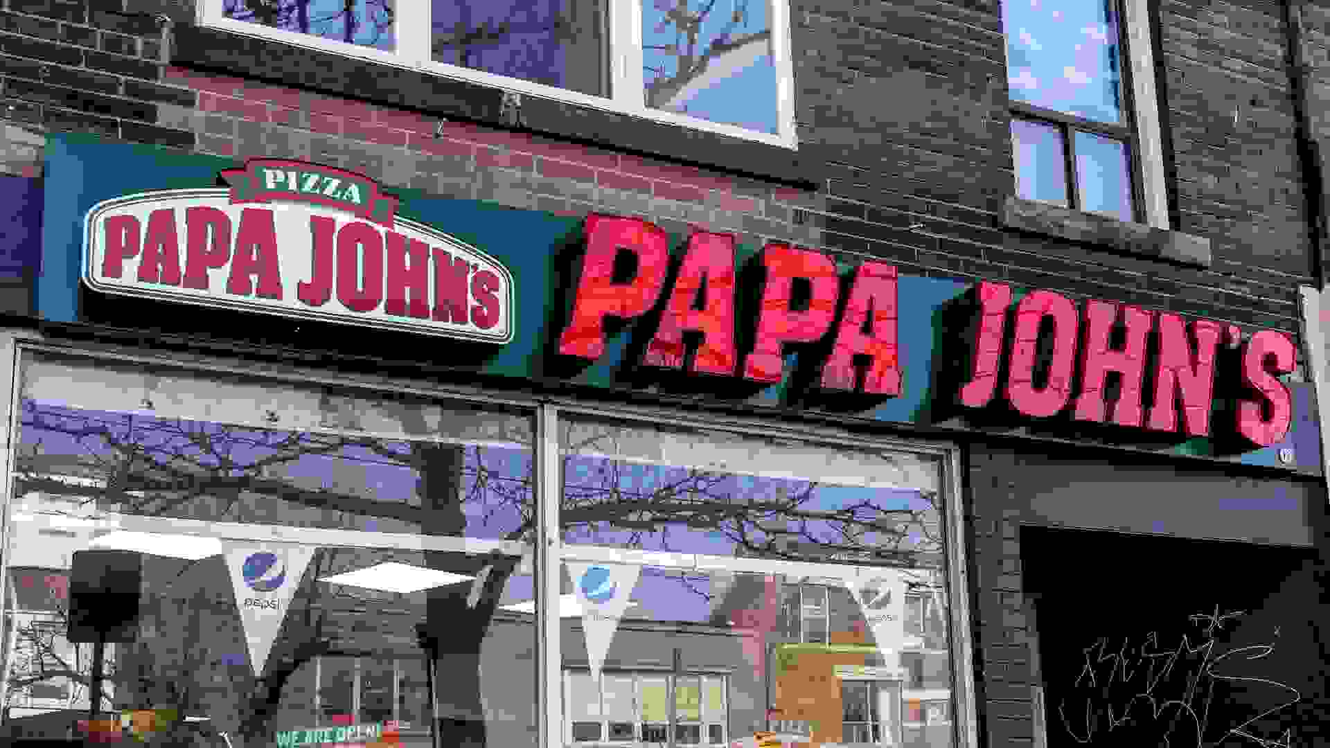 Papa John's restaurant sign in downtown Toronto. stock photo