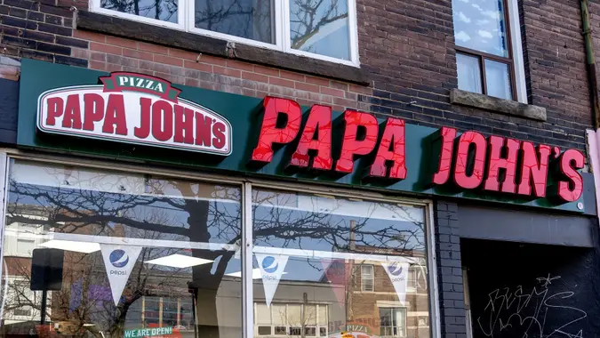 Papa John's restaurant sign in downtown Toronto. stock photo