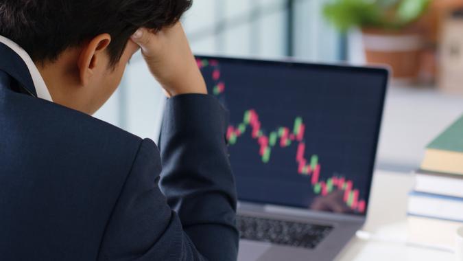 Stressed businessman feels desperate in crisis stock market, investment concept.  stock photo