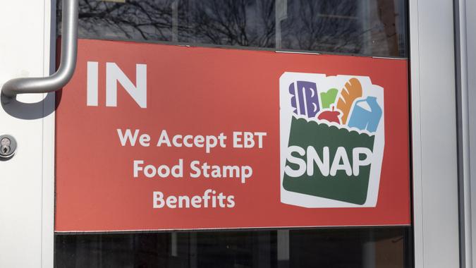 SNAP and EBT Accepted here sign. SNAP and Food Stamps provide nutrition benefits to supplement the budgets of disadvantaged families. stock photo