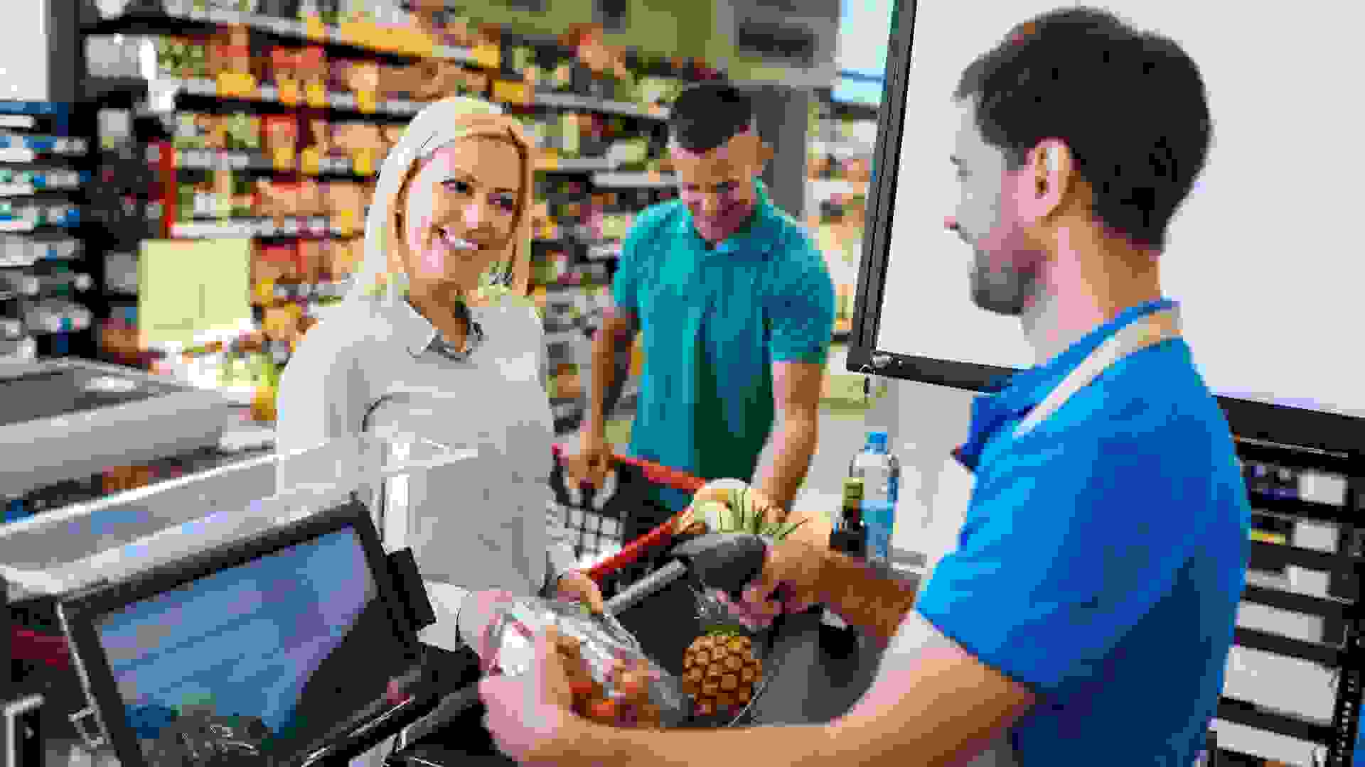 Family buying groceries in supermarket and making decisions what to buy stock photo