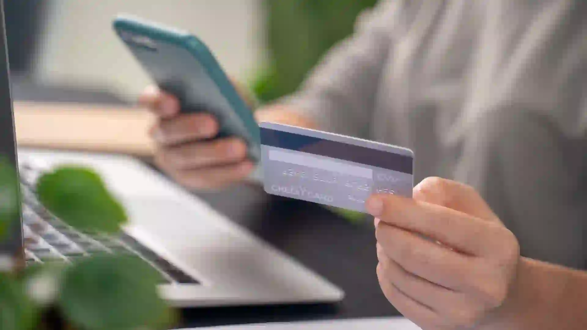 Close up shot of hands holding credit card typing message on smart phone for shopping online stock photo