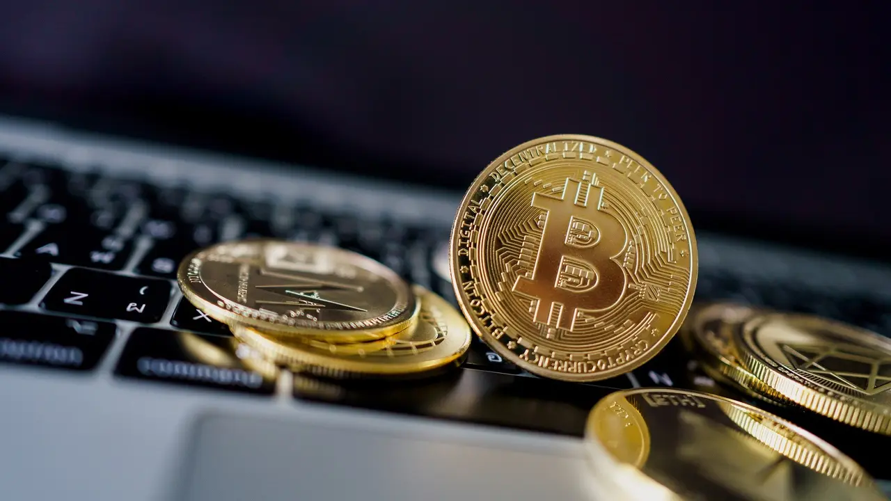 Photo Golden Bitcoins on laptop.  Cryptocurrency trading concept.  stock photo