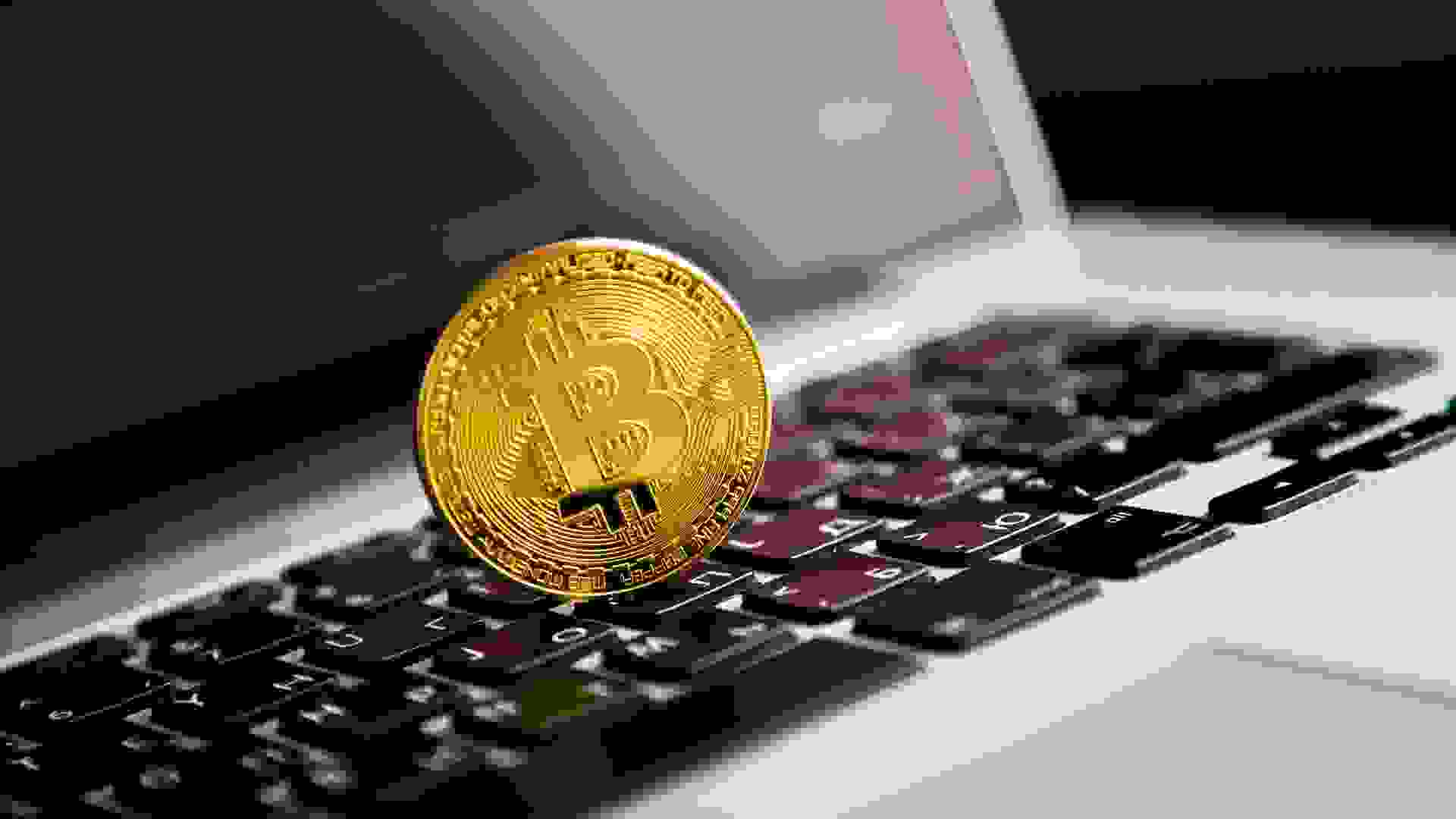 Bitcoin on the laptop. Black background. stock photo
