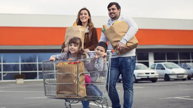 Family after shopping on parking lot. stock photo