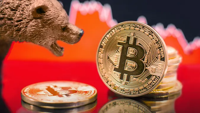 Bitcoin coins in a close-up shot, digital currency price crash concept.