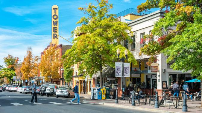 Pedestrians cross street in downtown Bend Oregon USA on a sunny day.