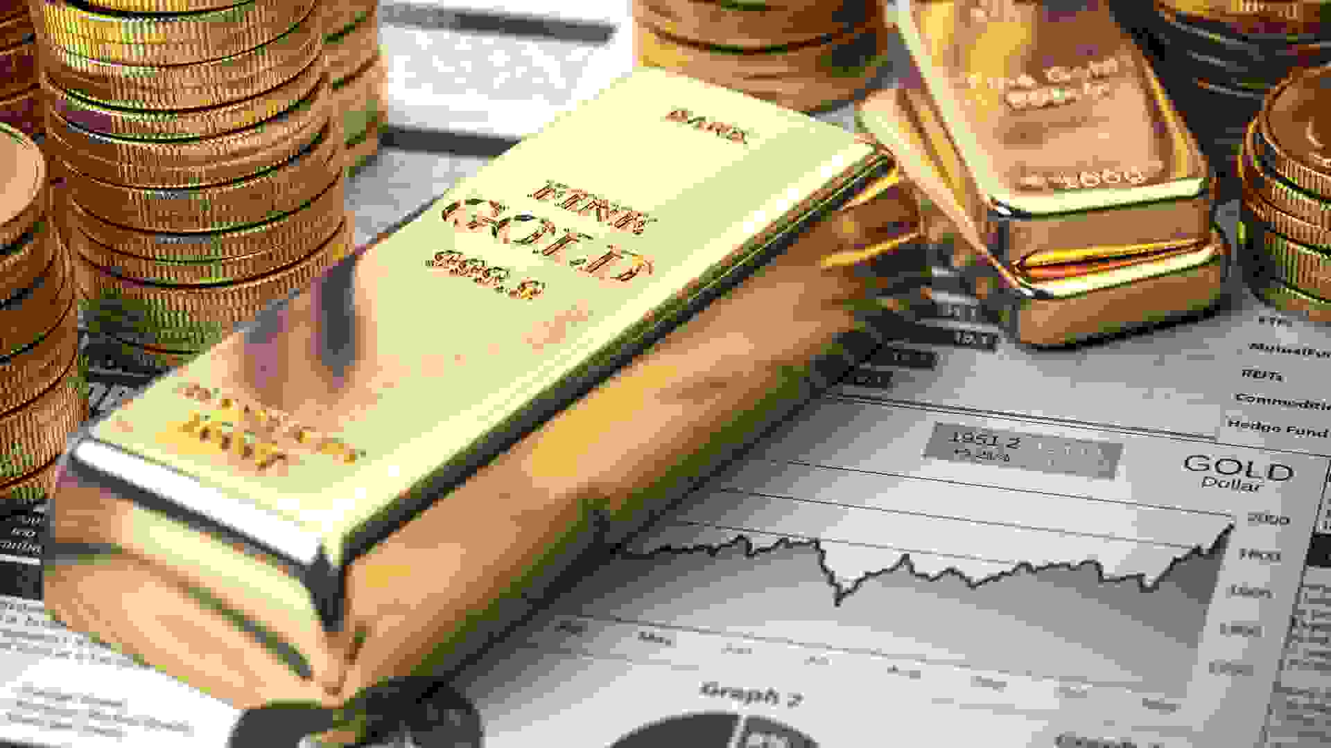 Gold bar, ingots and coins on financial  report.