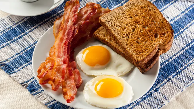 Organic Sunnyside up Egg with toast and bacon for breakfast.