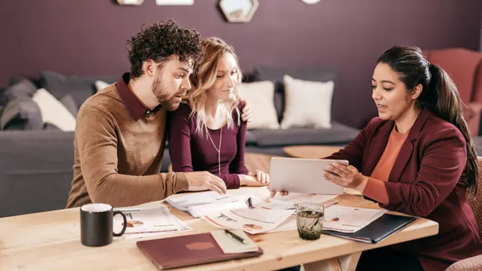 Couple and mortgage broker in the living room.