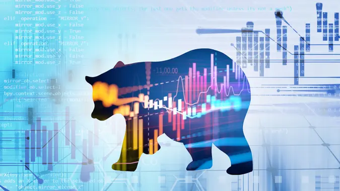 silhouette form of bear on financial stock market graph represent stock market crash or down trend investment.