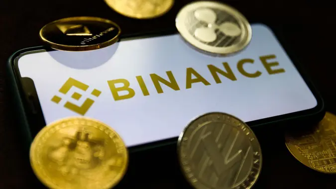Mandatory Credit: Photo by Jakub Porzycki/NurPhoto/Shutterstock (12172783a)Binance logo displayed on a phone screen and representation of cryptocurrencies are seen in this illustration photo taken in Krakow, Poland on June 28, 2021Binance Photo Illustrations, Krakow, Poland - 28 Jun 2021.