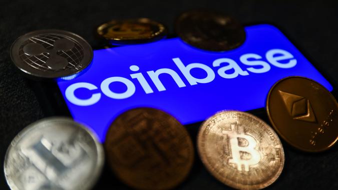 Mandatory Credit: Photo by Jakub Porzycki/NurPhoto/Shutterstock (12496465d)Coinbase logo displayed on a phone screen and representation of cryptocurrencies are seen in this illustration photo taken in Krakow, Poland on September 28, 2021.