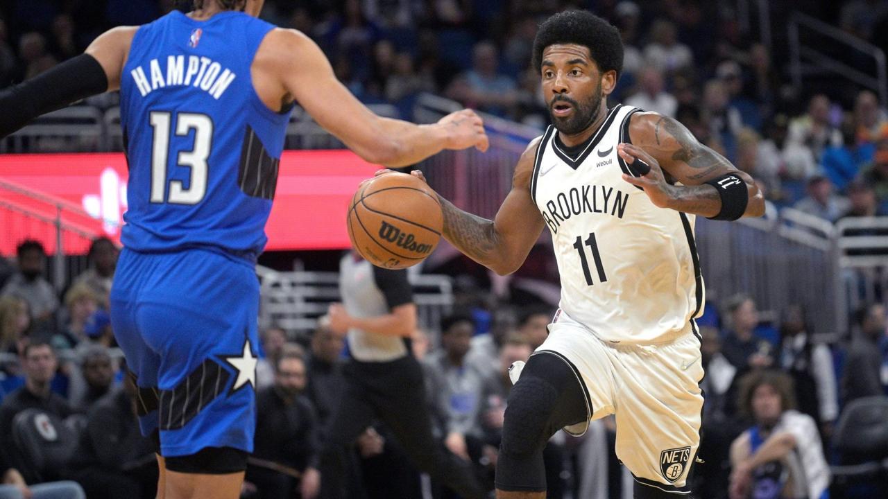 Mandatory Credit: Photo by Phelan M Ebenhack/AP/Shutterstock (12863998a)Brooklyn Nets guard Kyrie Irving (11), who is not permitted to play games in New York because he's unvaccinated for COVID-19, drives against Orlando Magic guard R.