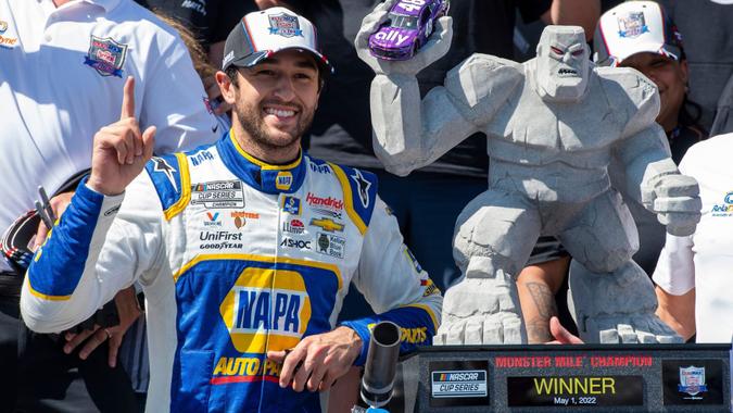 Mandatory Credit: Photo by Jason Minto/AP/Shutterstock (12921478e)Chase Elliott gestures next to his trophy after a NASCAR Cup Series auto race at Dover Motor Speedway, in Dover, DelNASCAR Cup Series Auto Racing, Dover, United States - 02 May 2022.