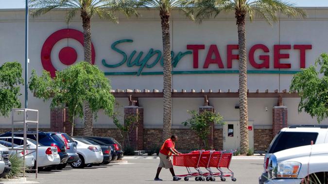 Mandatory Credit: Photo by Matt York/AP/Shutterstock (6289662a)A Target employee retrieves shopping carts outside a Target store in Gilbert, Ariz.