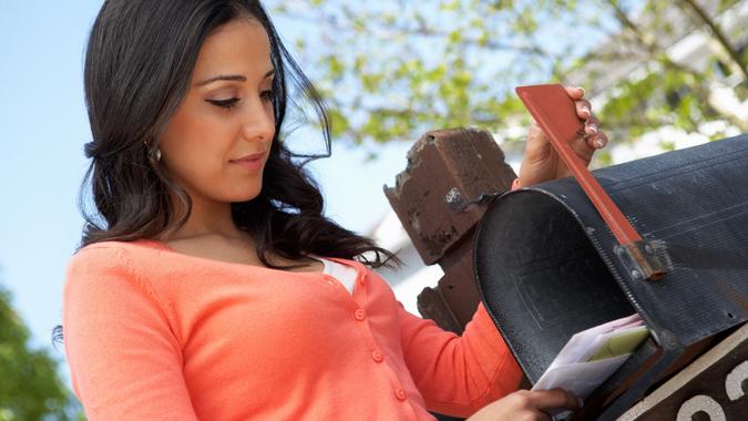 Hispanic Woman Checking Mailbox stock photo